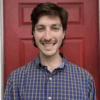 Headshot of Joseph DiSalvo in front of a red door