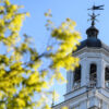 A clocktower against a blue background