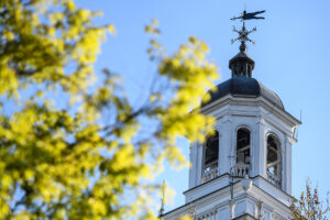 A clocktower against a blue background