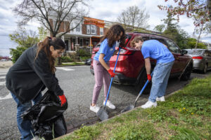 Students sweep up in Charles Village during Off-Campus Housing's Neighborhood Clean-Up event