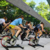 A group of students participating in an outdoor cycling class.