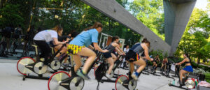 A group of students participating in an outdoor cycling class.
