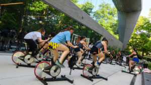 A group of students participating in an outdoor cycling class.