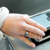 Close up of a student's arm as they are scanning their J-card on a reader.