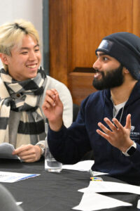 Two students speaking with one another