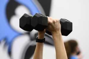 Close up on a pair of hands lifting weights.