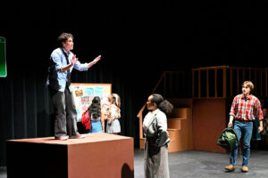 Students performing a play on stage